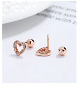Macro view of rose gold plated hollow heart screw-back stud earrings with S925 hallmark