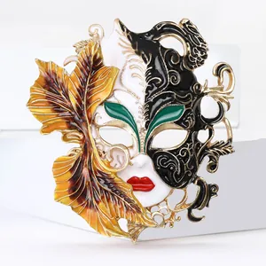 Intricate enamel Carnival mask brooch with gold-toned leaf detail and scrollwork