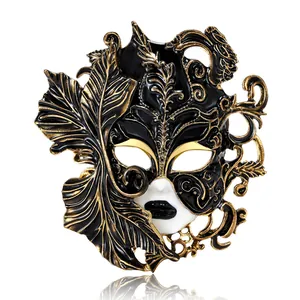 Exquisite vintage black and gold enamel Venetian mask brooch with intricate feather detail