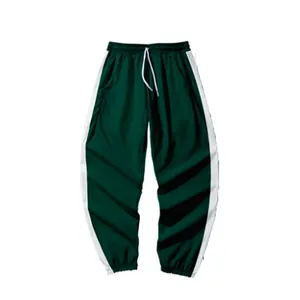 Pantalon de jogging enfant vert foncé avec rayures blanches et cordon