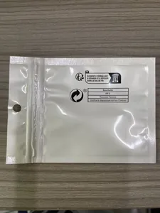 Close-up detail showing the white recyclable plastic zip bag for necklace packaging