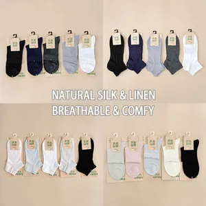 Detailed view of various colorful cotton and linen socks for women with tags