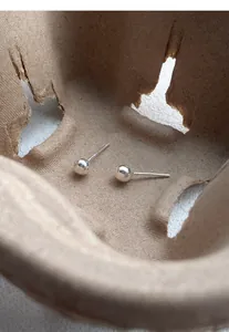 Detailed macro view of minimalist S999 sterling silver polished bead stud earrings