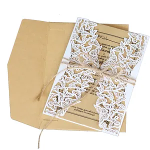 Elegant laser-cut white butterfly invitation set with kraft envelope and hemp twine