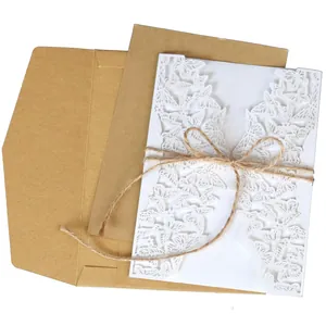 White laser-cut butterfly invitation card with kraft envelope and rustic twine.