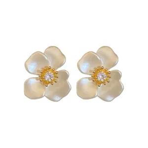 Elegant white flower stud earrings with gold plating and sparkling zircon center stones