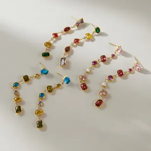 Detailed view of luxury stainless steel tassel earrings with vibrant multi-color gemstones