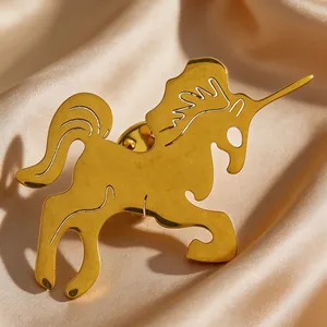 Detailed view of a golden unicorn brooch pin on elegant champagne satin fabric