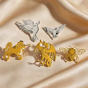 Detailed view of stainless steel animal brooches in bird, dragon and bee shapes