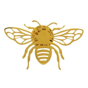 Detailed macro view of a gold honeybee brooch made of polished stainless steel metal