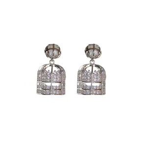 Elegant silver-toned birdcage drop earrings with shimmering zirconia and pearl accents.