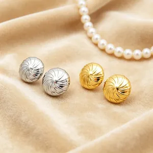 Elegante Ohrstecker aus Edelstahl in Gold und Silber mit Spiralstruktur auf Samt.