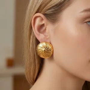 Detaillierte Nahaufnahme der Spiraltextur und des Goldfinishs auf dem Ohrstecker