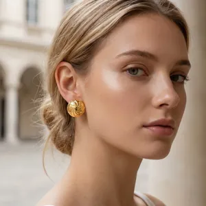 Detailansicht eines eleganten vergoldeten Spiralsteckers aus Edelstahl an einem Model