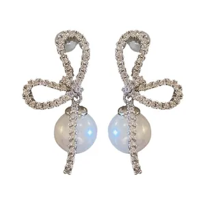 Elegant silver needle bow stud earrings featuring sparkling zircons and hanging pearls