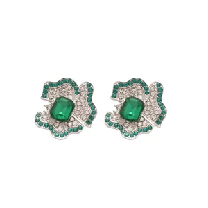 Luxurious silver flower stud earrings featuring emerald green stones and fine crystals