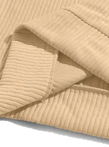 Detailed macro view showing the textured ribbed fabric and quality stitching of the shirt