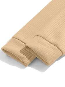 Macro detail shot showing the ribbed cuffs and texture of a beige men's sweatshirt.