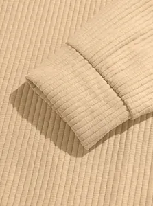 Detailed view of the premium ribbed knit fabric texture and elastic cuff on a men's sweatshirt