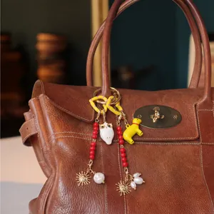 Bijou de sac perlé DIY tendance avec pendentifs hibou et chien sur un sac en cuir