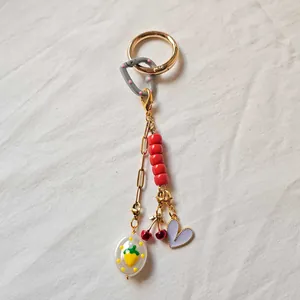 DIY fashion keychain featuring colorful heart and cherry charms on a gold chain link