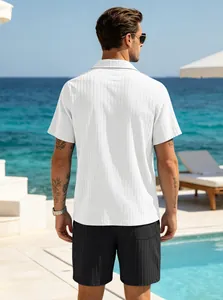 Back view of men's white short-sleeved button shirt and black shorts set in resort
