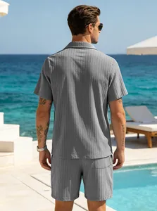 Detailed back view of men's grey ribbed shirt and shorts vacation set at a resort.