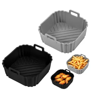 Detailed view of reusable square silicone air fryer liners in black and grey with handles