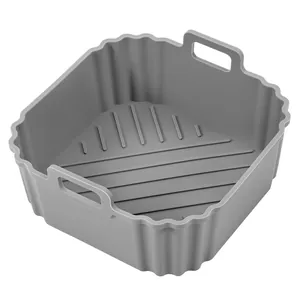 Square grey silicone air fryer liner with side handles for easy kitchen baking.