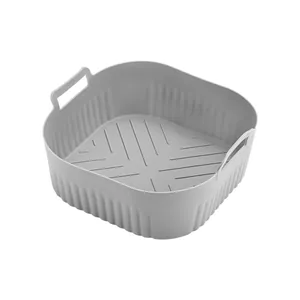 Gray square silicone air fryer liner with handles and textured bottom on white background