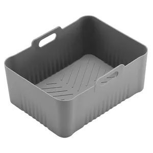 Detailed view of the textured bottom and handles of the gray silicone air fryer liner