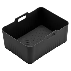 Macro view of black rectangular silicone air fryer liner with durable side handles