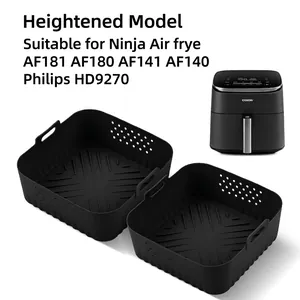 Detail view of two black square silicone air fryer liners with handles and side vents