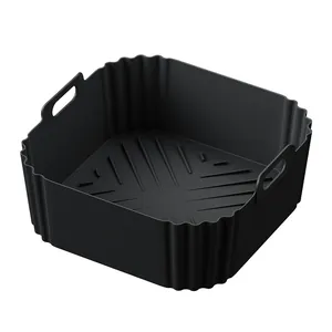 Detailed macro view of a square black silicone air fryer liner with integrated handles.