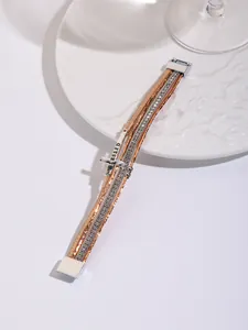 Macro detail of Bohemian multi-layer PU leather bracelet featuring a cross and rhinestones