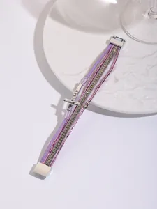 Detail view of multi-layer Bohemian bracelet with BLESSED cross and rhinestones