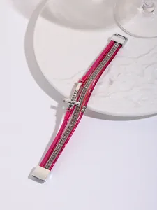 Detail view of pink multi-layer Bohemian bracelet with cross charm and magnetic clasp
