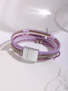Detailed view of bohemian multi-layer purple leather bracelet with magnetic clasp and cross