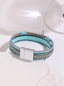 Detailed view of a Bohemian multi-layer PU leather bracelet with a crystal cross charm
