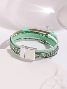 Detailed view of bohemian mint green multi-layer leather bracelet with cross and rhinestones