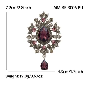 Vintage purple crystal pendant brooch with an ornate silver metal frame design