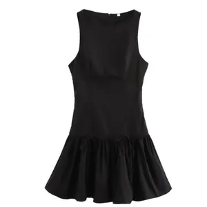 Sleeveless round neck black dress featuring a flared skirt and bow accents