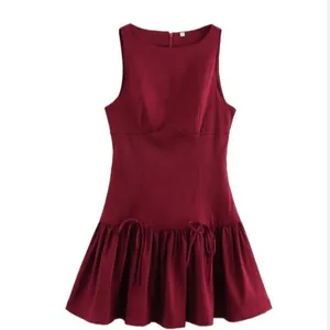Elegant sleeveless round neck burgundy dress with pleated hem and cute bow details.