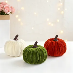 Detailed macro view of three colorful velvet artificial pumpkins for autumn decor.