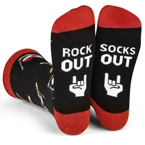 Detailed view of black and red cotton socks with white Rock Out knit text on soles