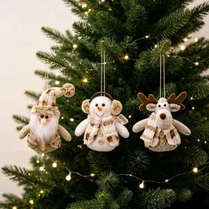 Detailed view of plush Santa, Snowman and Reindeer ornaments on a Christmas tree