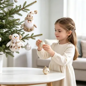 Little girl decorating Christmas tree with plush snowman and gnome hanging ornaments