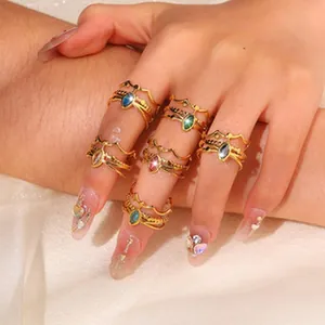 Detailed view of vintage gold bohemian rings set with colorful teardrop gemstones