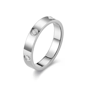 Silver stainless steel band ring featuring inset sparkling cubic zirconia stones.