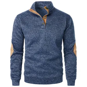 Front view detail of men's textured blue knit sweater with brown elbow patches and buttons.